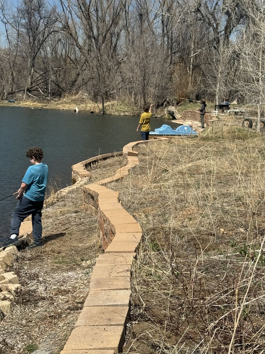 Students fly fishing along the pond at Temple Grandin School