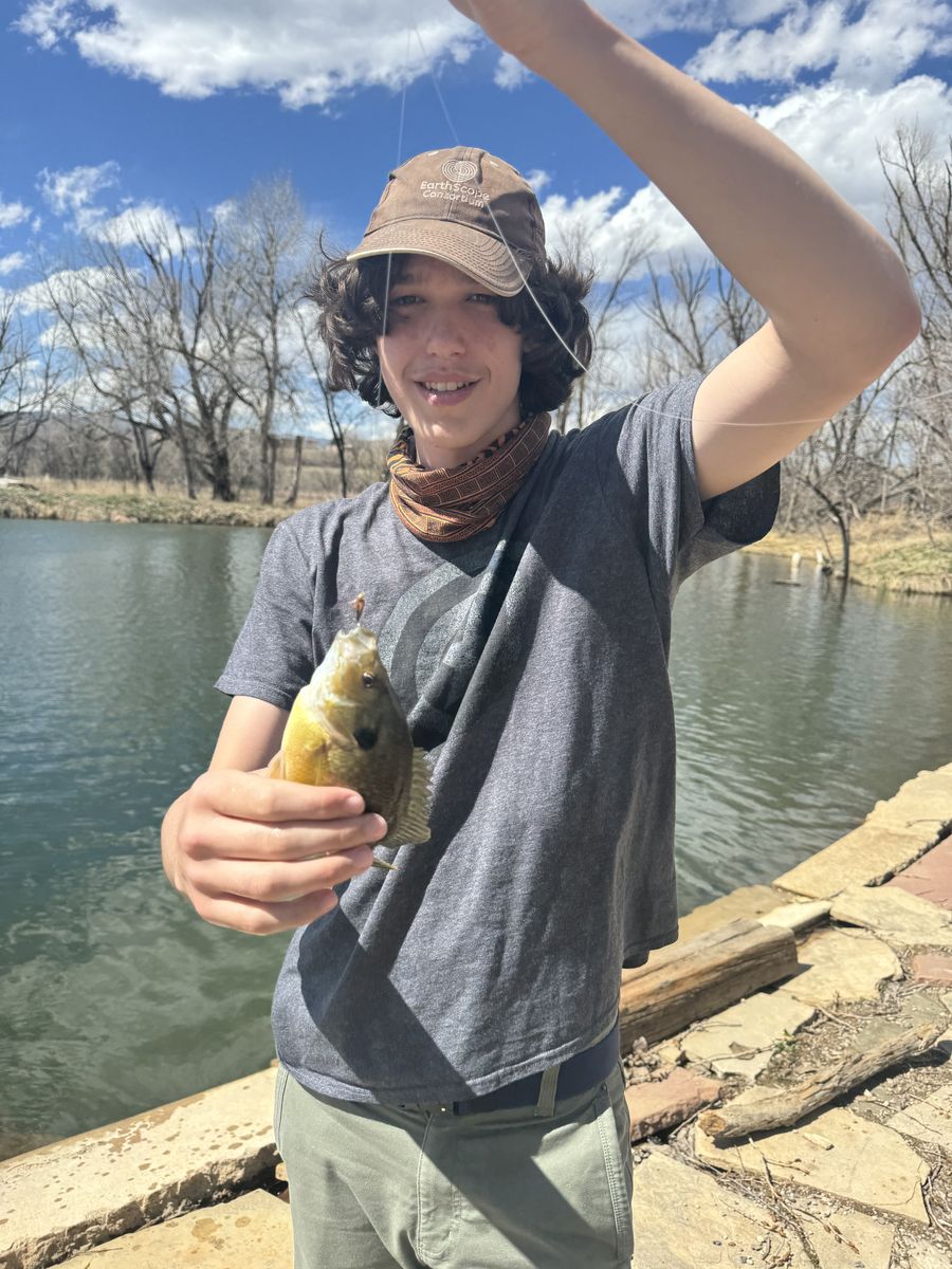 Student holding a fish caught on a fly