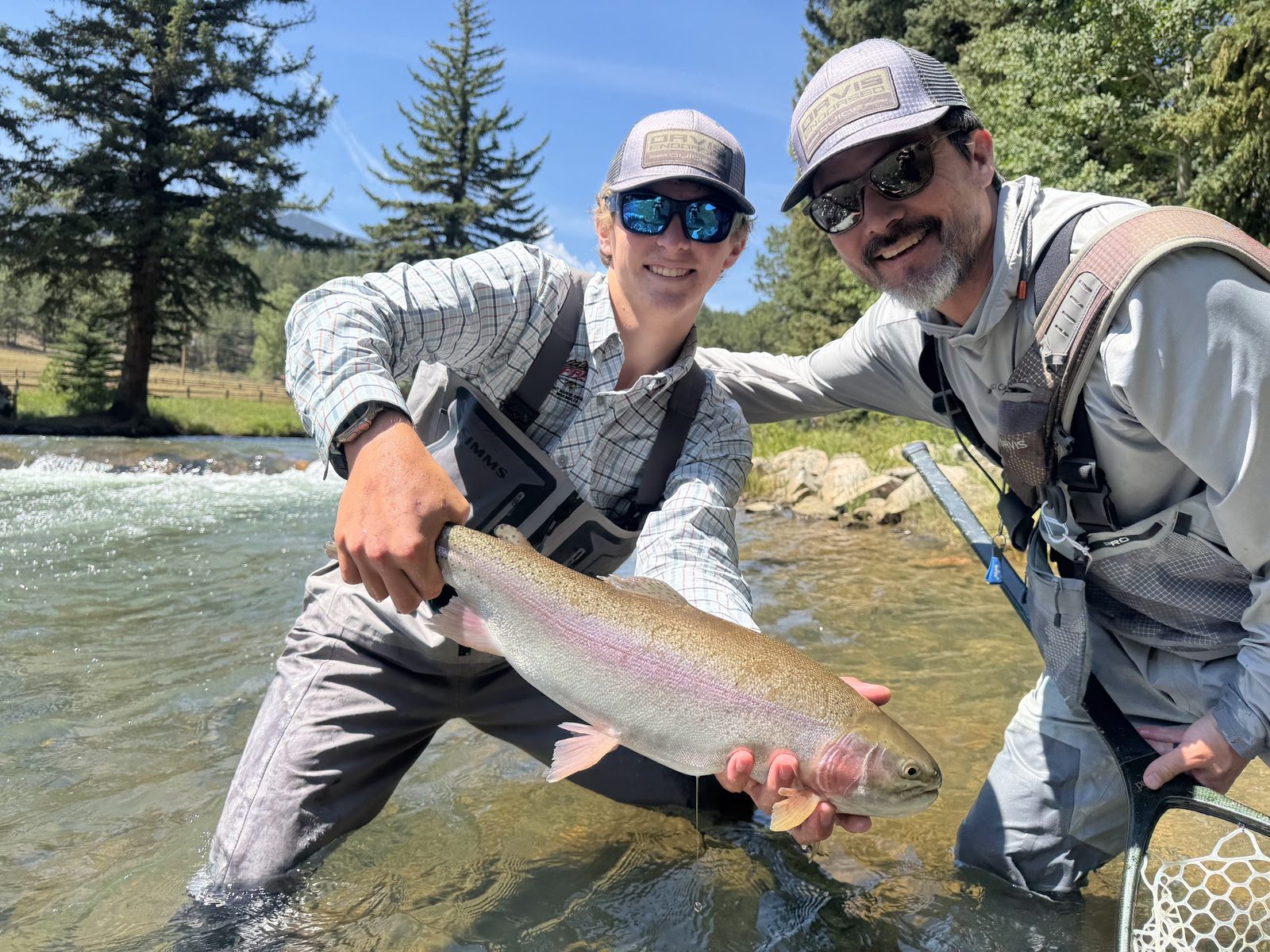 Anglers holding a large trout at North Fork Ranch